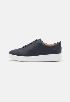 Navy blue leather sneakers with a smooth texture, white rubber sole, and simple lace-up design, featuring stitching details along the sides.