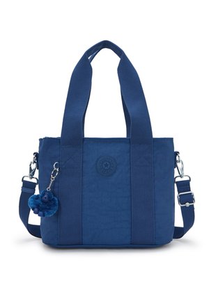Navy blue tote bag with wide handles, detachable shoulder strap, round logo patch on front, and small plush keychain attached to strap.