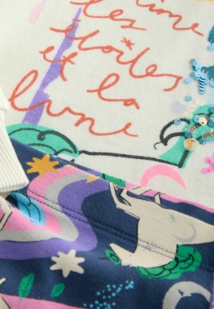 Sweater featuring a cream base, colorful printed graphics with stars, moons, and a unicorn design; embellished with sequins and contrasting fabric.