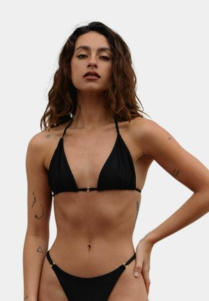 Black bikini set featuring a triangular top with thin straps and a gold hardware detail, paired with matching low-rise bottoms.