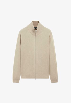 Maglione con zip beige, colletto alto, polsini e orlo a coste. La texture morbida, il design minimalista e la finitura liscia contribuiscono al suo aspetto moderno.