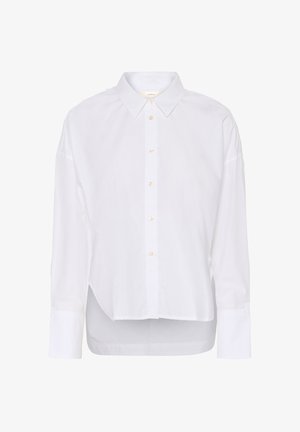 Bílá košile s dlouhým rukávem na knoflíky, s špičatým límcem, mírně delším zadním lemem a velkými manžetami.