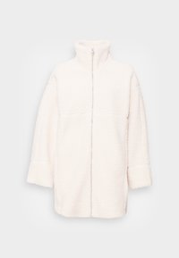 Kermansiru sherpa fleece takki korkealla kauluksella, pitkillä hihoilla, edessä olevalla vetoketjulla ja rentolla istuvuudella.