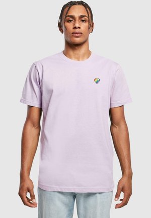 Lilac cotton t-shirt with short sleeves and a crew neck, featuring a small rainbow heart embroidery on the left chest.