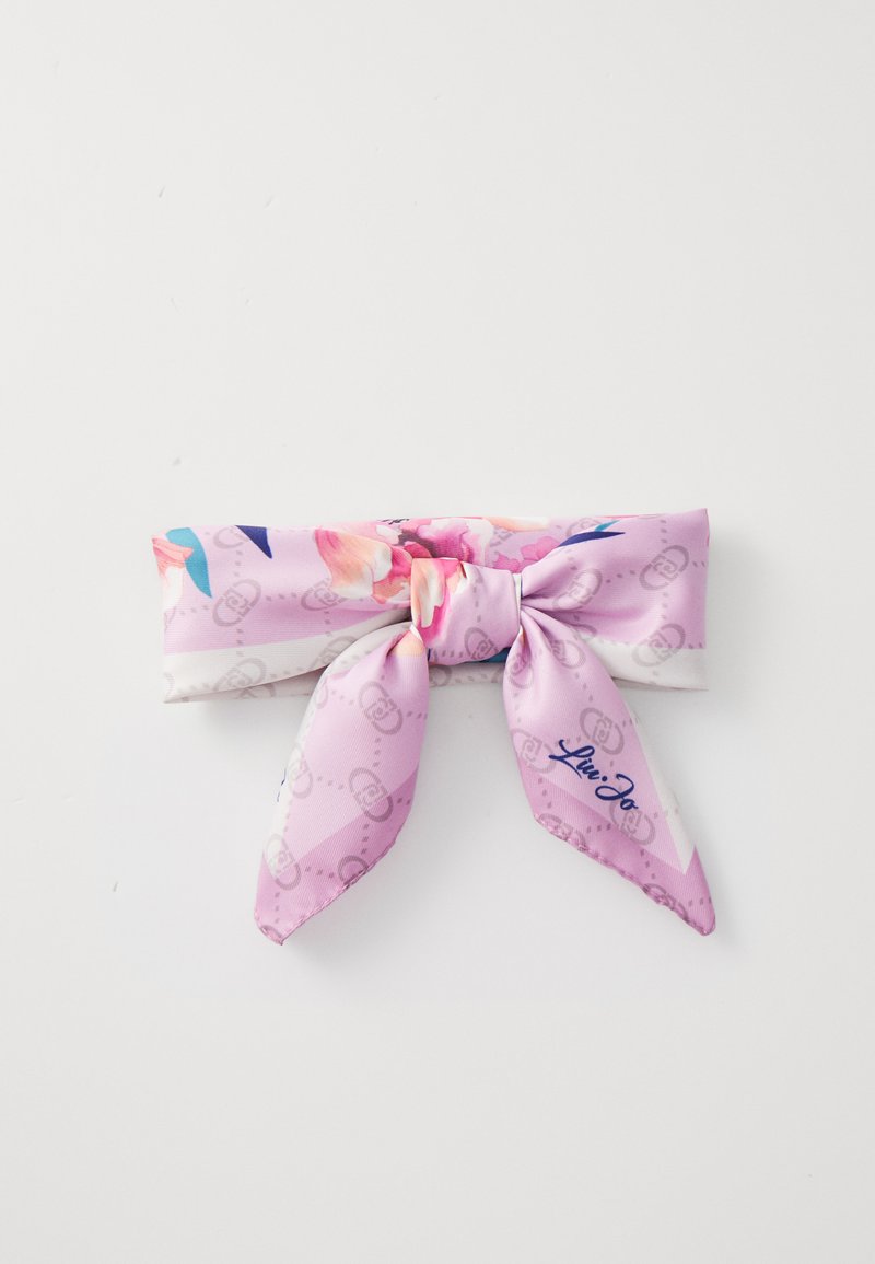 Fascia per capelli in seta rosa con un motivo floreale e un nodo al centro, caratterizzata da due nastri allungati e un logo blu.