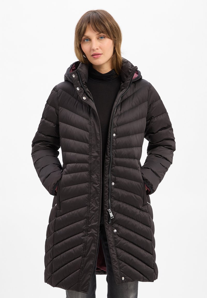 Black puffer coat with a hood, featuring vertical quilted texture, zip closure, snap buttons, and side pockets. Lined with a contrasting color.