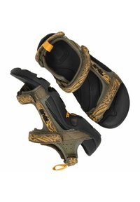 Green and brown sandals feature a textured, adjustable strap design with a black rubber sole and yellow accent for added grip.