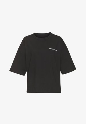 Black cotton oversized t-shirt with short sleeves, round neckline, and "CPH STUDIOS" logo printed in white on the left chest area.