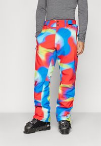 Pantalones de esquí coloridos con un patrón en espiral de rojo, azul y amarillo. Fabricados con material duradero, cuentan con bolsillos frontales y cinturilla ajustable.