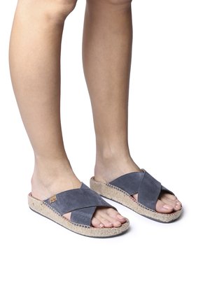 Gray suede sandals with an espadrille-style jute sole, featuring cross straps and a textured surface. Open-toe design, lightweight construction.