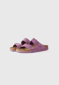 Purple suede sandals with two adjustable straps, cork footbed, and textured rubber sole. Open-toe design with flat profile.