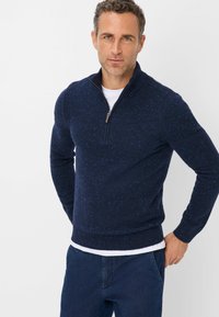 Dunkelblauer Zip-Hals Pullover mit gesprenkelter Textur. Verfügt über einen gerippten Saum und Ärmelbündchen, aus weichem Stoff für einen bequemen Sitz.