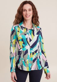 Mehrfarbiges Hemd mit einem lebhaften abstrakten Muster in Grün, Blau, Pink und Marineblau; lange Ärmel, Knopfverschluss vorne und weicher Stoff.