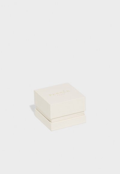 Kvadrāta formas, krēmkrāsas rotaslietu kaste ar gludu tekstūru un zelta uzrakstu "PERSÉE PARIS" uz vāka. Kastei ir vienkāršs dizains.