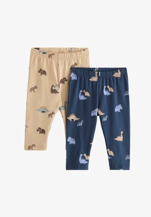 Dva páry dětských legín; jedny béžové s barevnými potisky dinosaurů, druhé tmavě modré se podobnými vzory. Měkké a elastické pásky v pase.
