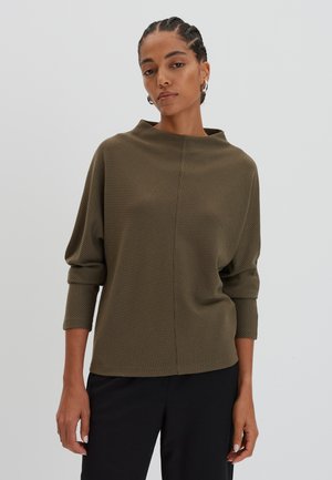 Olive green, textured long-sleeve top with a loose fit and high boat neckline. Features dropped shoulders and soft fabric.