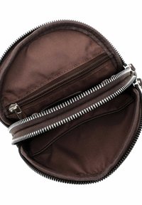 Round brown pouch open to show interior with two zippered compartments and fabric lining.