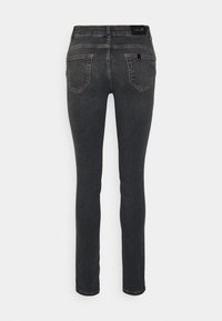 Jeans skinny grigio scuro con vita media, design a cinque tasche e dettagli di cucitura sottili lungo le cuciture.