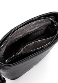 Black leather shoulder bag with a zip closure, featuring a textured exterior and a smooth interior lining with a subtle pattern.