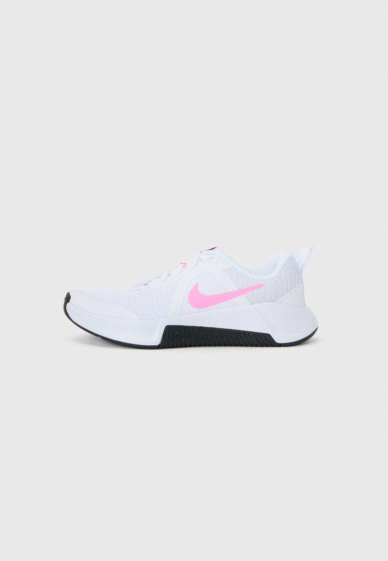 White athletic shoe with mesh upper, pink logo, and black rubber outsole. Features textured side panel and lace-up closure.