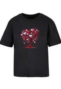 Black t-shirt with a graphic of a heart-shaped tree, featuring pink and red hearts and a brown trunk, set against a solid background.