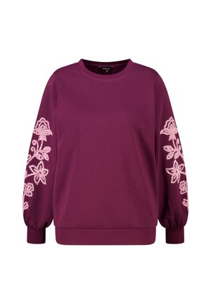 Sweat-shirt bordeaux avec manches longues bouffantes ; présente une broderie florale rose sur la manche gauche. Col et poignets côtelés ; texture douce.