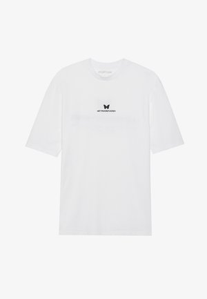 White cotton t-shirt with short sleeves, featuring a black butterfly graphic and the word "METAMORPHOSIS" printed above it.