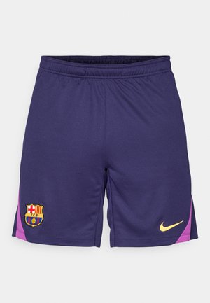 Dark purple sports shorts with pink side accents, featuring FC Barcelona crest on left leg and yellow Nike logo on right leg.