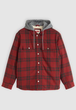 Red plaid shirt with a grey hood liner, white buttons, and two front pockets. Made of soft fabric with a button-down design.