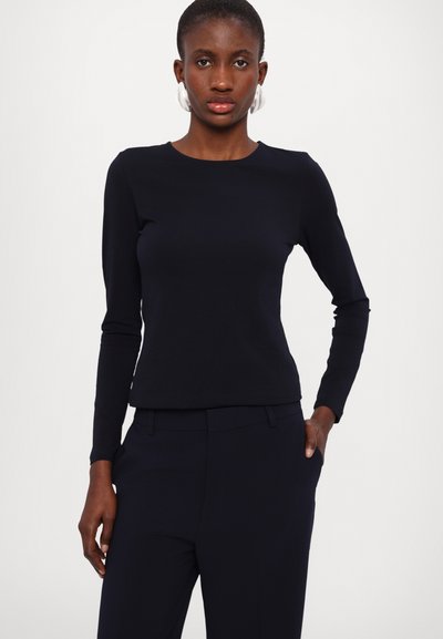 Navy long-sleeve top made of stretchy fabric, featuring a round neckline and slim fit. Paired with matching tailored pants.