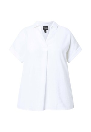 Blouse blanche à manches courtes avec col en V et coupe ample, avec une étiquette de marque à l'intérieur de l'encolure.