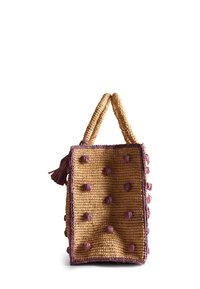 Borsa di paglia intrecciata di colore naturale con dettagli viola, caratterizzata da una forma rettangolare, due manici e accenti a pompon testurizzati.