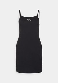 Abito slip in jersey di cotone nero con sottili spalline a spaghetto. La parte frontale presenta un logo bianco "cK" vicino al colletto. Texture liscia, design aderente.