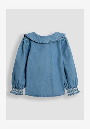 Denim särg pikka puffi varrukatega, volangkaeluse ja smockimise detailidega varrukatel. Hea sinine värv, sile tekstuur ja regulaarne lõige.