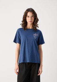 Navy blue t-shirt in a relaxed fit, featuring short sleeves and an embroidered design on the left chest area. Soft, lightweight fabric.