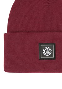 Beanie a magenta in maglia con risvolto e una patch nera quadrata con un logo circolare bianco e un design di albero. Texture morbida e vestibilità elastica.