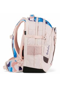 Backpack in light pink fabric with a patterned blue and purple strap. Features padded shoulder straps and multiple compartments.