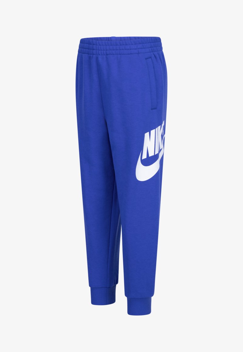 Swekpants azuis de algodão com uma cintura elástica, bolsos laterais e um grande logótipo branco da Nike na coxa esquerda. Tornozelos com punho.