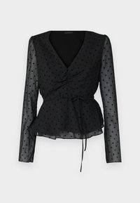 Blusa nera trasparente a maniche lunghe con pois, scollatura a V, davanti arricciato, vita con fiocco e orlo leggermente svasato.