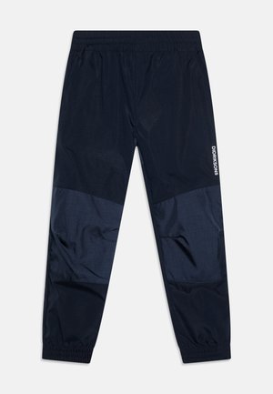 Navy tuulitakkihousut elastisella vyötäröllä, joissa on sileät ja tekstuuriset kangaspaneelit, brändätty yksityiskohta sivulla.