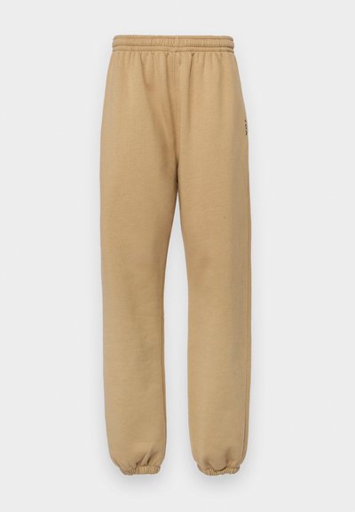 Beige sweatpants gemaakt van zachte stof, met een elastische tailleband en boorden, zijnaden en een klein logo op de linkerdij.