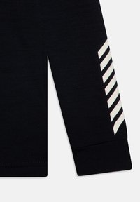 Maglietta nera a maniche lunghe con una texture a coste. Presenta strisce bianche diagonali lungo la manica sinistra e un orlo a polsino.