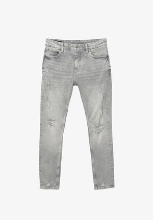 Lichtgrijze skinny jeans met versleten delen op de dijen en knieën, vijf-pocket ontwerp en knoopsluiting.