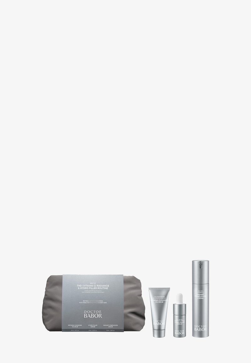 Skincare kit with three silver bottles and tubes labeled Doctor Babor, displayed next to a gray pouch with product details on the label.