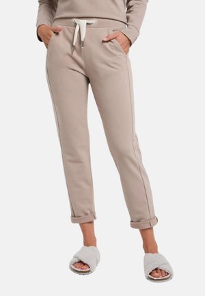 Beige sweatpants with a drawstring waist, side pockets, and rolled cuffs. Made of soft fabric with contrasting white stitching details.
