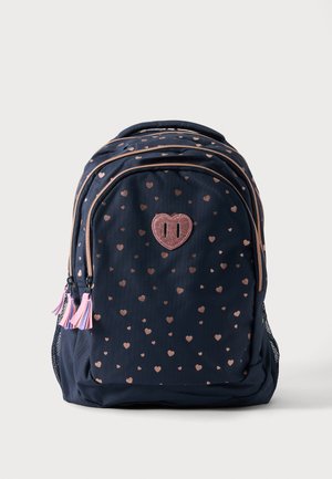 Navy blue backpack with rose gold heart patterns, pink tassel zipper pulls, and a large glittery heart-shaped patch in the center.