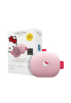 Brosse faciale Hello Kitty Sonic en rose doux, avec une texture nervurée et un accent de visage de chat blanc. Emballée dans une boîte colorée avec des détails.