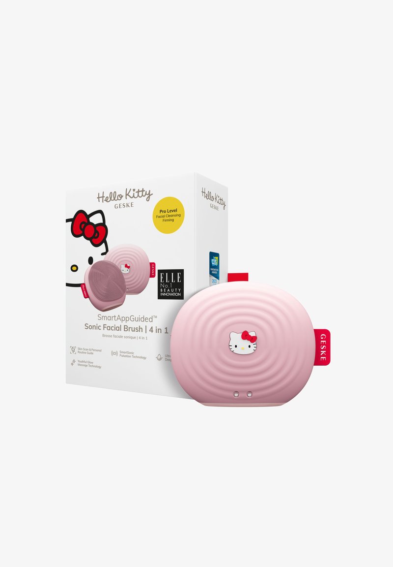 Hello Kitty sonic ansigtsbørste i blød pink, med en ribbet tekstur og en hvid katteansigt accent. Pakkeri i en farverig æske mærket med oplysninger.