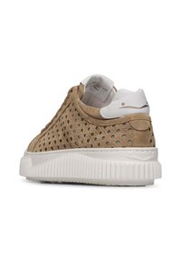 Zapatilla de ante perforado en color marrón con suela de goma blanca, trasera texturizada y pequeño logotipo en el talón. Presenta una forma redondeada y patrones texturizados.