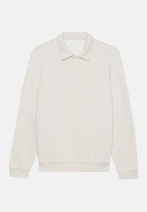 Camisa polo de manga longa em creme, feita de tecido suave. Apresenta um colarinho clássico, abertura com três botões e punhos canelados.